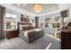 Serene main bedroom featuring tray ceilings, generous natural light, neutral tones, and plush carpet flooring at 780 Ben Ledi Ct, Raleigh, NC 27603