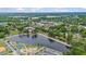 Picturesque aerial view of the lake near downtown with mature trees and town buildings at 789 Old Station Pointe, Angier, NC 27501