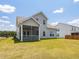 Back of a two-story home with a screened porch and spacious lawn at 789 Old Station Pointe, Angier, NC 27501