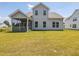Back of a two-story home with a screened porch and spacious lawn at 789 Old Station Pointe, Angier, NC 27501