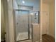 Bathroom features tiled walk-in shower with glass door, a bench, and a double sink vanity at 789 Old Station Pointe, Angier, NC 27501