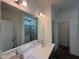 Bathroom features double sink vanity, large mirror, modern lighting, and a tiled walk-in shower at 789 Old Station Pointe, Angier, NC 27501