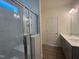 Bathroom features double sink vanity, modern lighting, and a tiled walk-in shower with glass door at 789 Old Station Pointe, Angier, NC 27501
