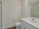 Bright bathroom featuring quartz countertops, a framed mirror, toilet, towel rack and a glass enclosed shower at 789 Old Station Pointe, Angier, NC 27501
