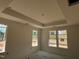 A bedroom featuring a tray ceiling and abundant natural light through several large windows at 789 Old Station Pointe, Angier, NC 27501