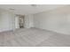 Spacious bonus room featuring carpet, baseboards, double French doors, and entry ways to other rooms at 789 Old Station Pointe, Angier, NC 27501