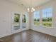 Dining room with backyard view, stylish lighting, and glass patio doors at 789 Old Station Pointe, Angier, NC 27501