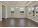 Bright dining area with hardwood floors, large windows, and tray ceiling detail at 789 Old Station Pointe, Angier, NC 27501