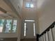 Welcoming entryway featuring a high ceiling, sidelights, and views of the windows and staircase at 789 Old Station Pointe, Angier, NC 27501