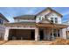 Exterior elevation of house under construction, showcasing its architectural design and attached garage at 789 Old Station Pointe, Angier, NC 27501