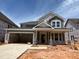 New construction, two-story home with a two-car garage and inviting front porch at 789 Old Station Pointe, Angier, NC 27501