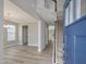 Bright foyer with wood flooring, staircase, and view into the adjacent living spaces at 789 Old Station Pointe, Angier, NC 27501