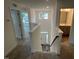 Bright hallway with white walls, carpeted floors, and a view of the front door and a room with many windows at 789 Old Station Pointe, Angier, NC 27501