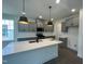 Stylish kitchen with gray cabinetry, a spacious island, and modern pendant lighting at 789 Old Station Pointe, Angier, NC 27501