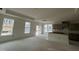 Bright kitchen with large windows and sliding glass door, showcasing tray ceiling and modern recessed lighting at 789 Old Station Pointe, Angier, NC 27501