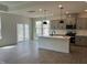 Open-concept kitchen boasts hardwood floors, gray cabinetry and island, and stainless steel appliances at 789 Old Station Pointe, Angier, NC 27501