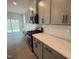 Modern kitchen with gray cabinets, stainless steel appliances, and a bright backsplash at 789 Old Station Pointe, Angier, NC 27501