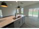 Open kitchen featuring a large island with breakfast bar, pendant lighting, and ample counter space at 789 Old Station Pointe, Angier, NC 27501