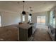 Modern kitchen featuring a large island, stainless steel appliances, and open layout at 789 Old Station Pointe, Angier, NC 27501