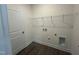 Convenient laundry room featuring wood floors, wire shelving for storage, and utility connections at 789 Old Station Pointe, Angier, NC 27501