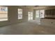 Bright living room with large windows, sliding glass doors, and an open kitchen area at 789 Old Station Pointe, Angier, NC 27501