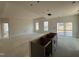 Open-concept living room and kitchen area with coffered ceilings, large windows, and sliding doors at 789 Old Station Pointe, Angier, NC 27501