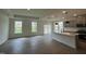 Open-concept living room and kitchen boasts hardwood floors and modern gray cabinetry and island at 789 Old Station Pointe, Angier, NC 27501