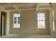 Living room with a coffered ceiling and large windows, offering plenty of natural light at 789 Old Station Pointe, Angier, NC 27501