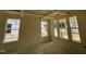 Living room featuring large windows providing natural light and an elegant coffered ceiling at 789 Old Station Pointe, Angier, NC 27501