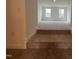 Spacious, carpeted living room with two windows and white walls, bathed in natural light at 789 Old Station Pointe, Angier, NC 27501
