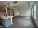 Spacious living room featuring an open floor plan, hardwood floors, recessed lighting, and access to the kitchen at 789 Old Station Pointe, Angier, NC 27501