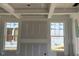 Unfinished living room featuring large windows, tray ceiling, and ample natural light at 789 Old Station Pointe, Angier, NC 27501