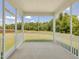 A screened porch offers serene views of greenery and an open outdoor space at 789 Old Station Pointe, Angier, NC 27501