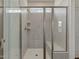 A modern bathroom showcasing a glass-enclosed shower with tiled walls, a built-in seat, and a window at 789 Old Station Pointe, Angier, NC 27501