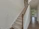 Carpeted staircase featuring wooden banister and white risers at 789 Old Station Pointe, Angier, NC 27501