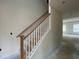 View of a staircase with a light wood railing in a home with natural lighting and neutral walls at 789 Old Station Pointe, Angier, NC 27501