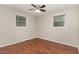 Neutral bedroom showcasing natural lighting from two large windows and ceiling fan at 820 Newcombe Rd, Raleigh, NC 27610