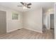 Bright living room featuring wood floors, a ceiling fan, and neutral wall paint at 820 Newcombe Rd, Raleigh, NC 27610