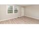 Bright living room with hardwood floors and a white front door entrance at 820 Newcombe Rd, Raleigh, NC 27610