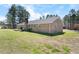 Expansive backyard featuring a home with a brick exterior, deck, and lawn at 916 Clayton Rd, Durham, NC 27703