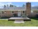 Open backyard with a wooden deck, a grill, an outdoor table and chairs on the lawn at 916 Clayton Rd, Durham, NC 27703