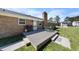 Nice backyard with a wooden deck, a grill, an outdoor table and chairs on the lawn at 916 Clayton Rd, Durham, NC 27703