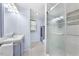 Bright bathroom featuring a glass enclosed shower, vanity with storage, and modern fixtures at 916 Clayton Rd, Durham, NC 27703