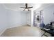 Bright bedroom features a ceiling fan, light blue walls, and a window with colorful curtains at 916 Clayton Rd, Durham, NC 27703