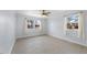 A spacious, bright bedroom with two windows and neutral flooring at 916 Clayton Rd, Durham, NC 27703