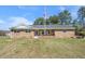 Charming single-story brick home featuring a well-manicured lawn and a welcoming front porch at 916 Clayton Rd, Durham, NC 27703