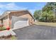 Brick home showing a large driveway leading to an attached two car garage with white door at 916 Clayton Rd, Durham, NC 27703