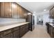 Long kitchen featuring stainless steel appliances, ample counter space, and stylish cabinetry at 916 Clayton Rd, Durham, NC 27703