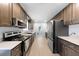 Galley kitchen with stainless steel appliances, ample counter space, and stylish cabinetry at 916 Clayton Rd, Durham, NC 27703