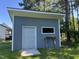 Modern outbuilding with roll-up door and a small window, providing extra storage space at 916 Clayton Rd, Durham, NC 27703